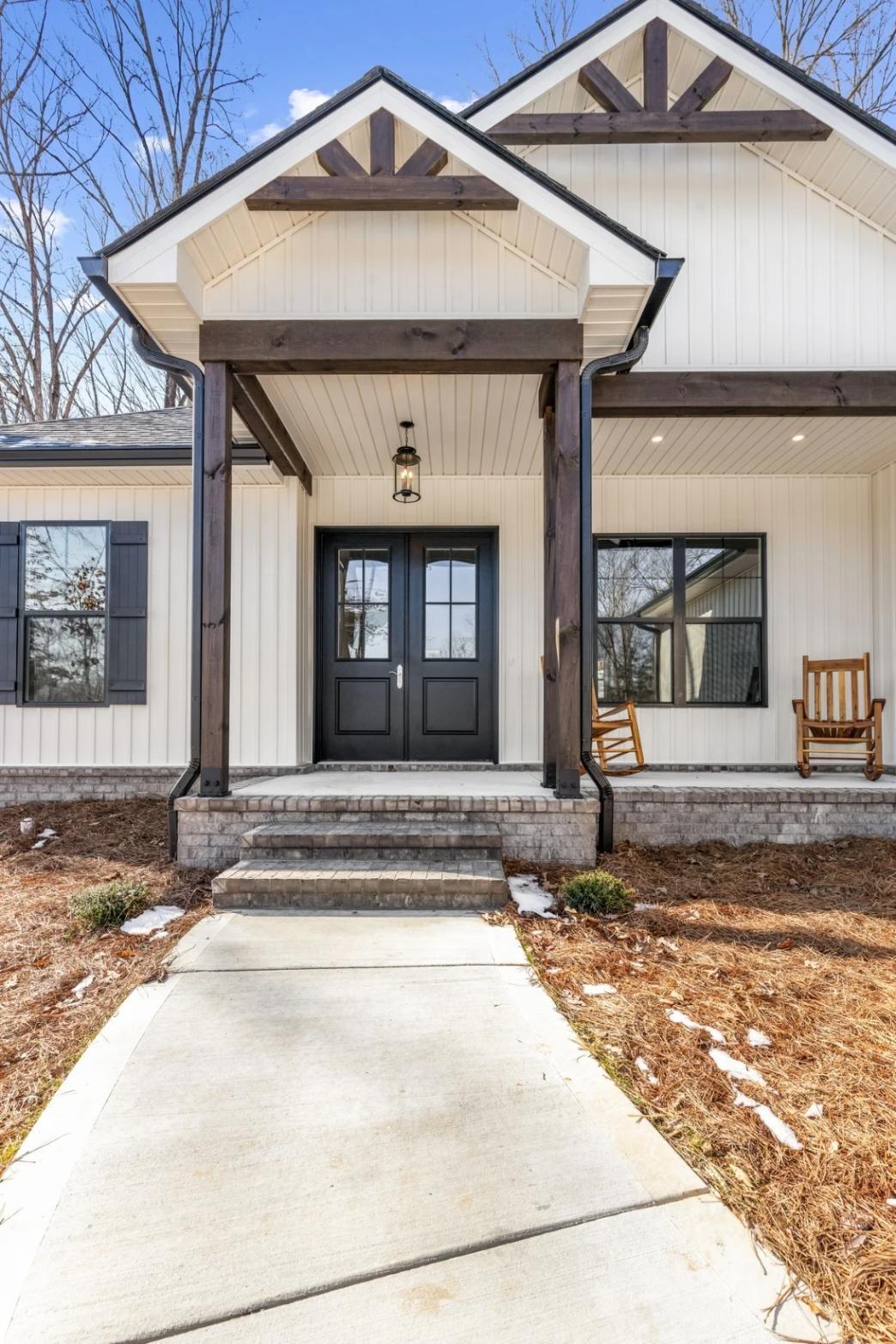 Covered front porch with black double doors on Vonore custom home in Knoxville, TN