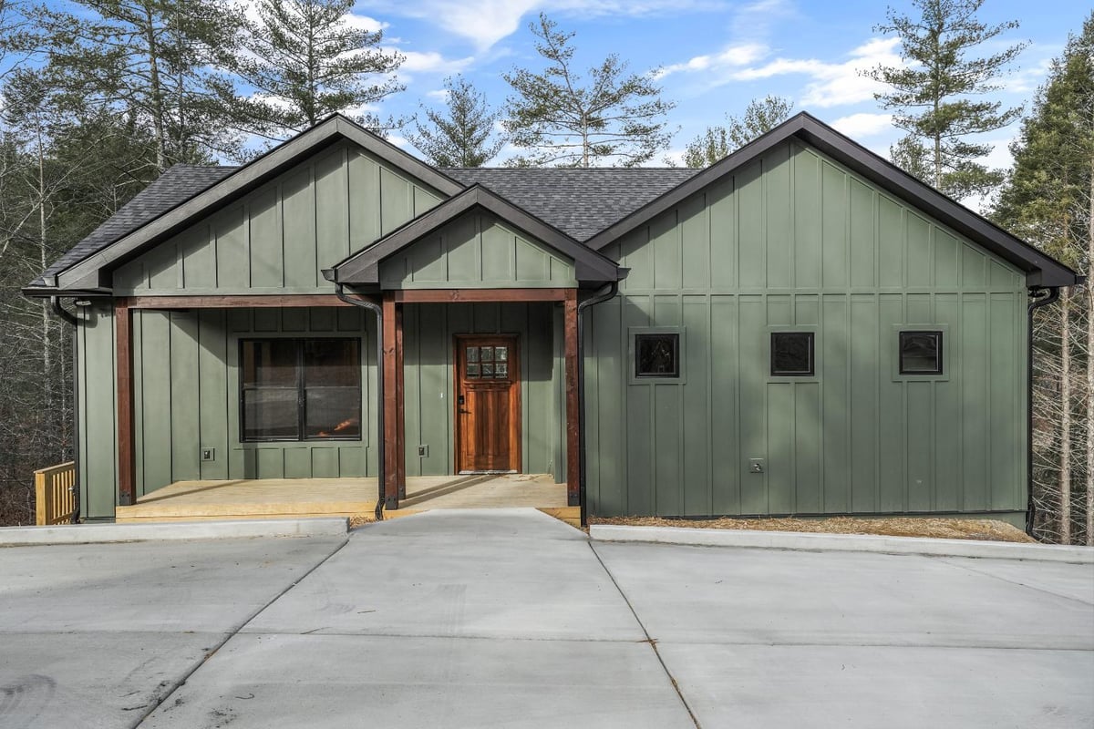 Front of green custom home in Louisville, TN by Debuty Builders, Inc.