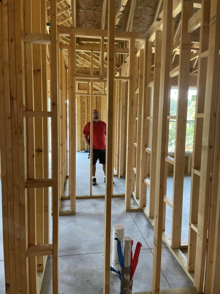 Construction worker inspecting framing inside a custom home in Knoxville, TN by Debuty Builders