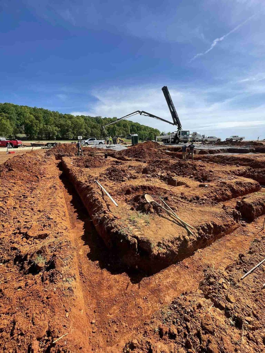 Wide shot of foundation excavation with construction equipment, Debuty Builders, Knoxville, TN
