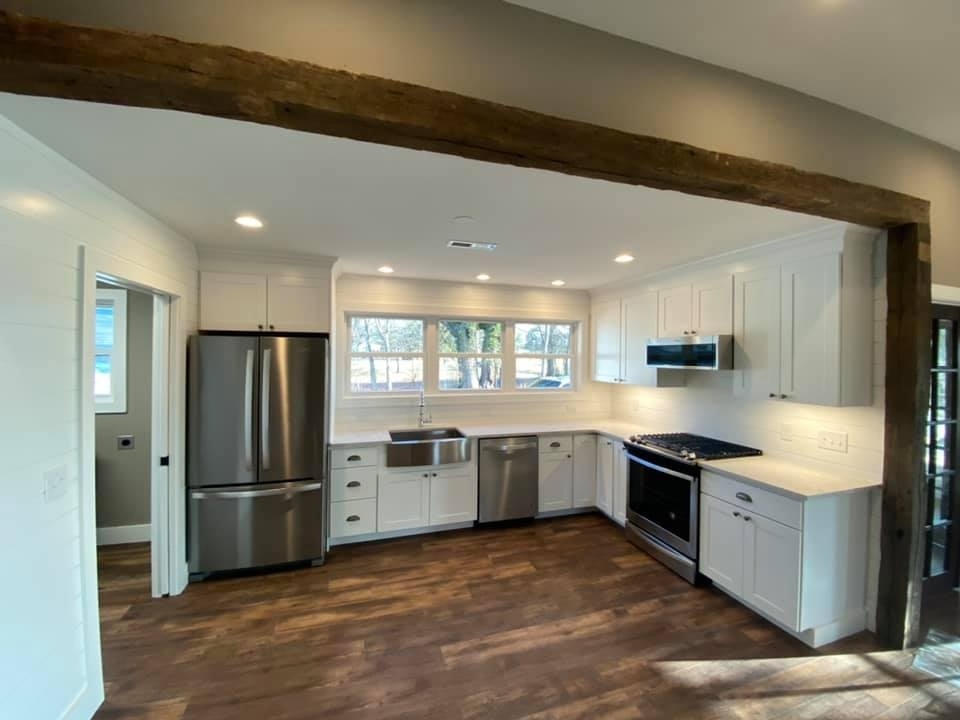 Custom farmhouse-style kitchen with stainless steel appliances in Knoxville remodeled by Debuty Builders