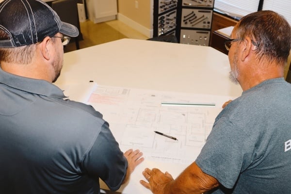 Debuty Builders team discussing blueprints for a home remodeling project in Knoxville, TN