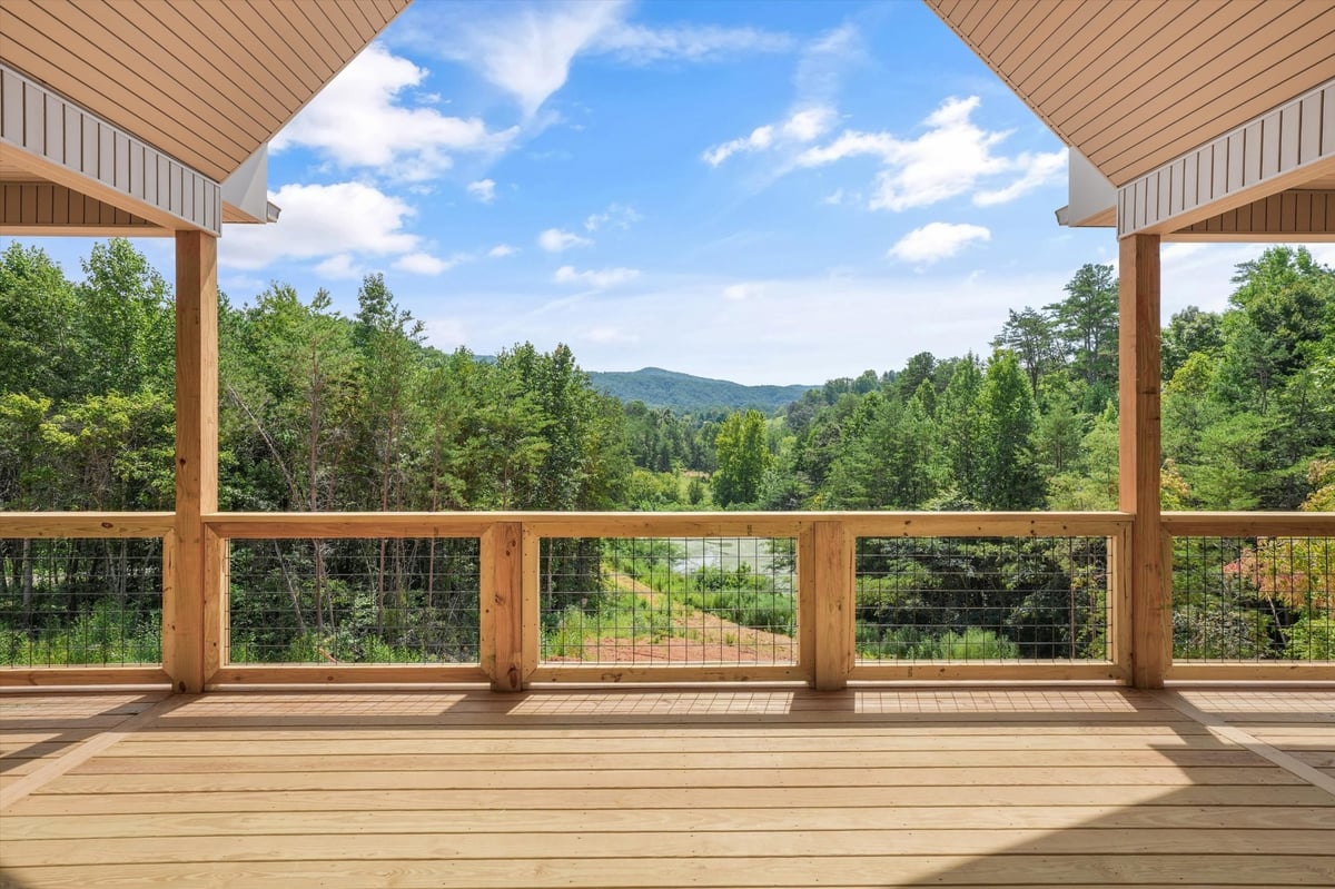 custom home covered deck overlooking wooded hills and pond in maryville tn