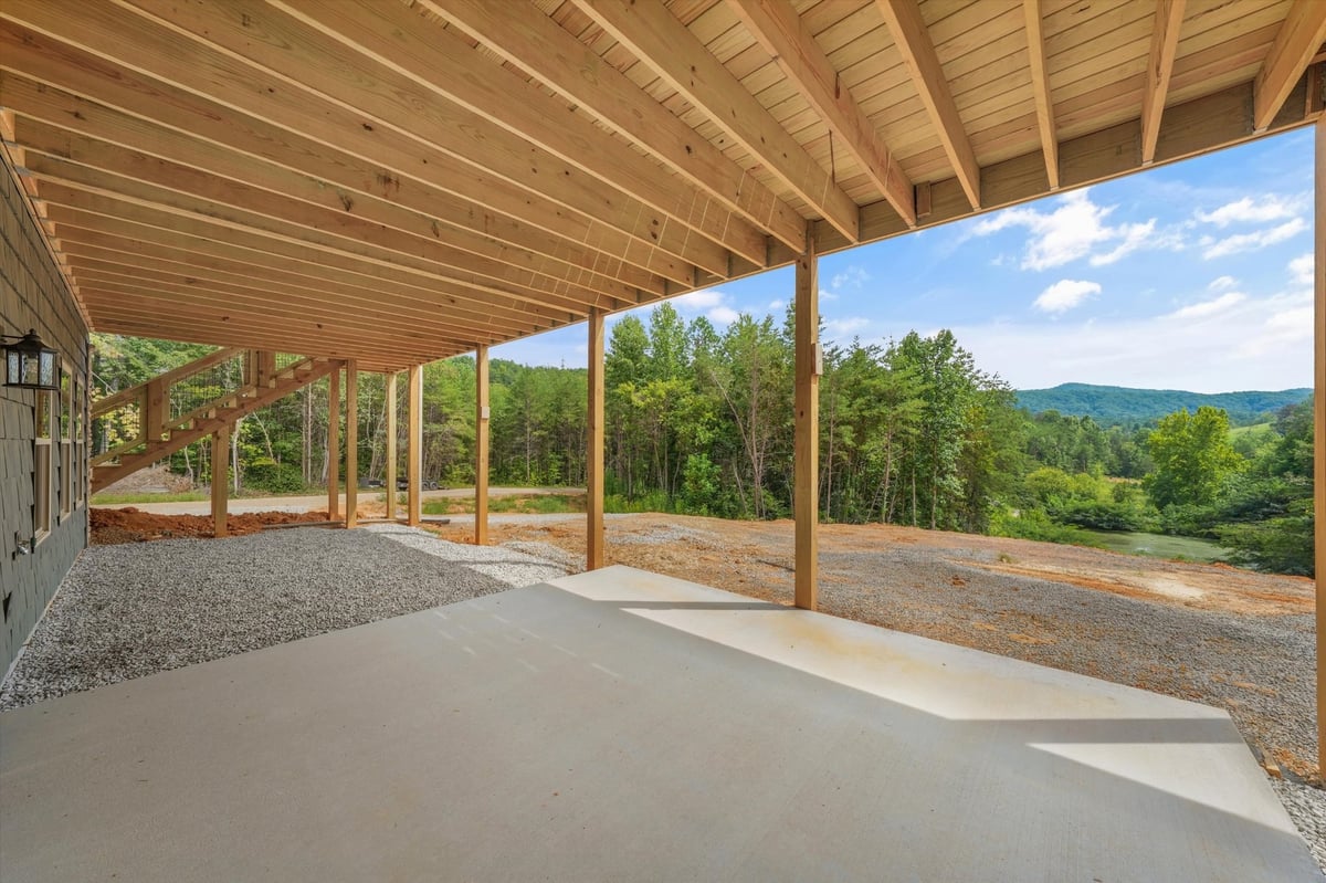 custom home covered lower patio with exposed wood framing and mountain views in maryville tn