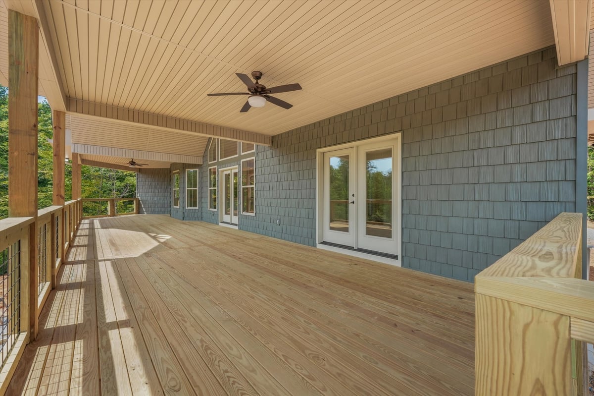 custom home covered rear deck with french doors wood flooring and ceiling fans in maryville tn
