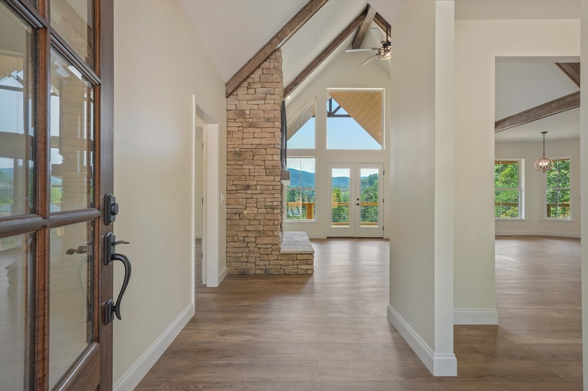 custom home entry hall with vaulted ceiling stone fireplace and mountain views in maryville tn