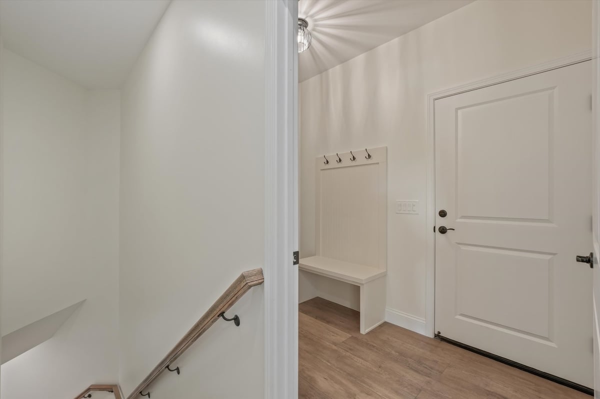 custom home mudroom entry with built in bench and wood look flooring in maryville tn