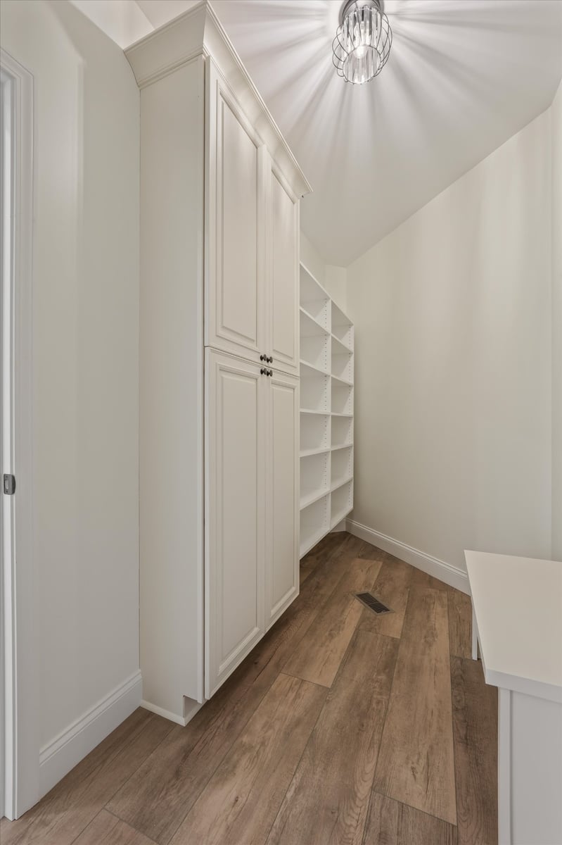 custom home mudroom storage with white cabinets and open shelving in maryville tn