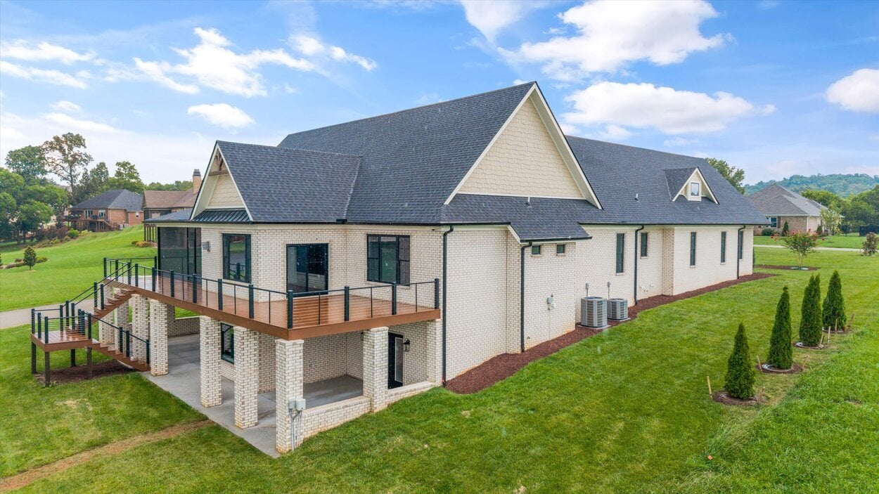 Angled exterior view showing deck and side yard of Louisville, TN Custom