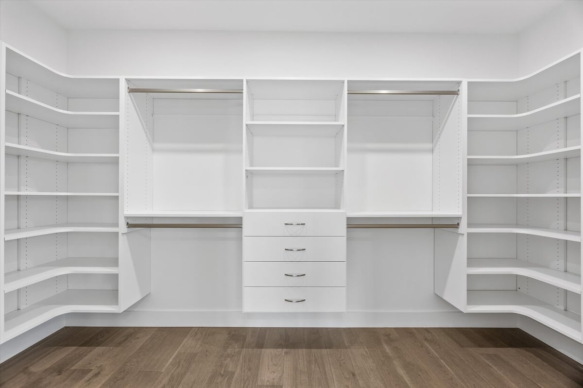 Custom walk-in closet in a Louisville, TN custom home with built-in drawers and ample shelving