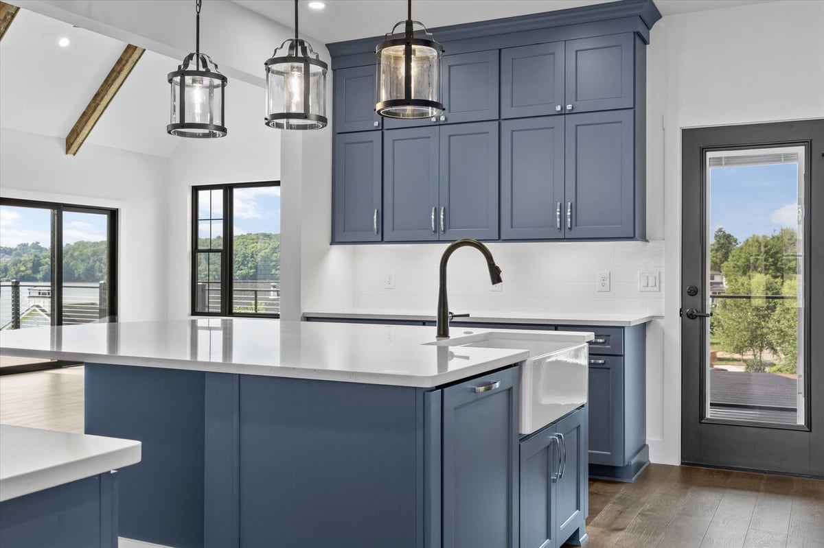 Kitchen with large island and scenic views in a Louisville, TN custom home featuring navy cabinetry