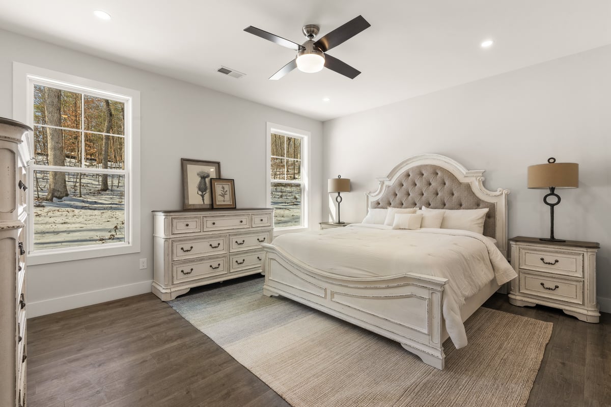 Bright primary bedroom with large windows in Vonore custom home in Knoxville, TN