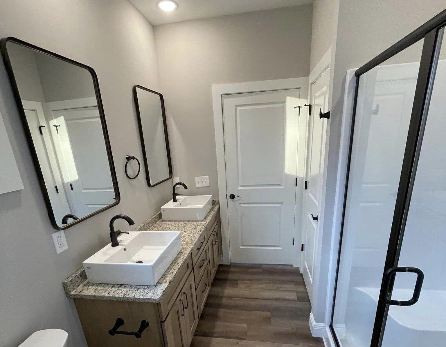 Bathroom with dual sinks and walk-in shower in custom home by Debuty Builders, Knoxville, TN