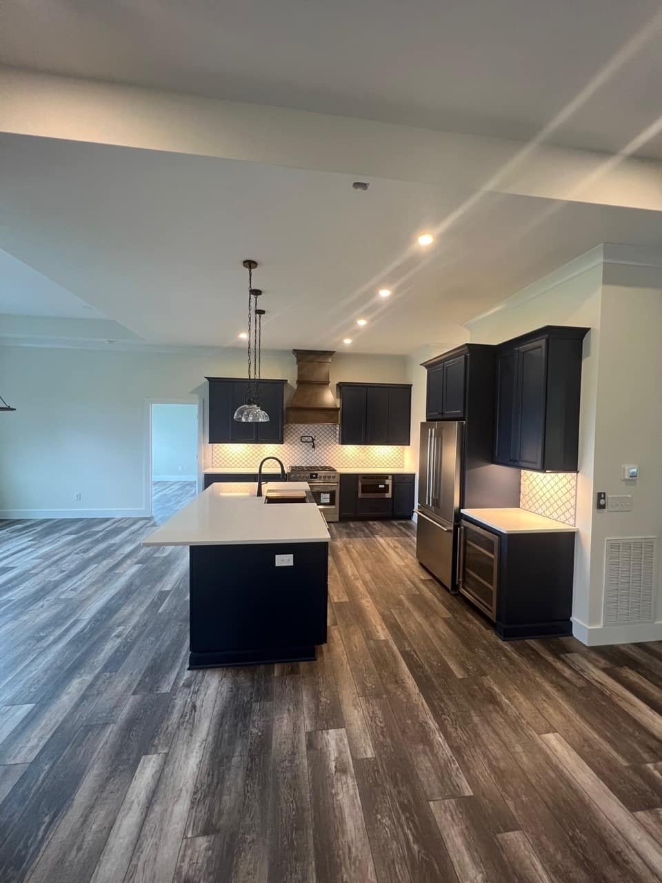 Modern kitchen with dark cabinets and island in a custom home by Debuty Builders, Knoxville, TN