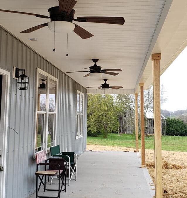 A large outdoor porch with ceiling fans in a custom-built home by Debuty Builders in Knoxville, TN