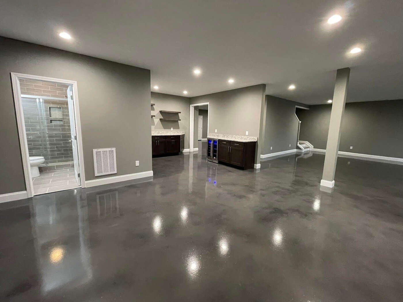 A polished basement with a modern kitchenette and bathroom, part of a custom home by Debuty Builders in Knoxville, TN