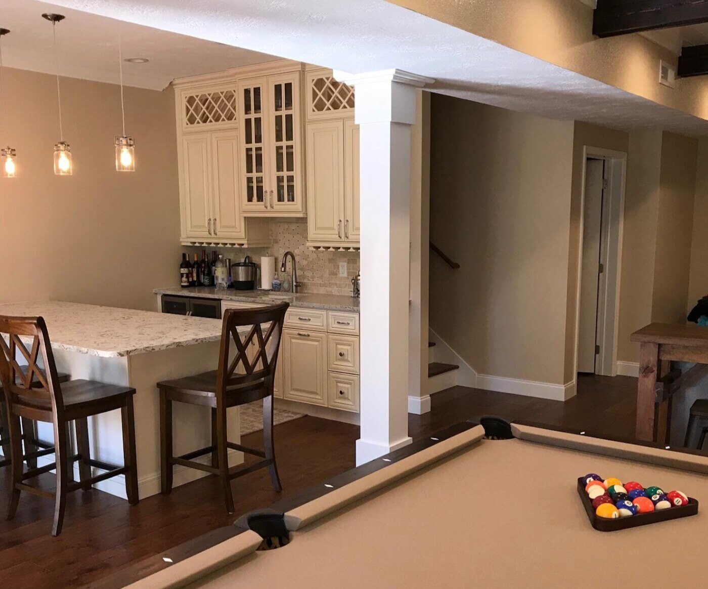 A warm, cozy game room with a pool table and kitchen in a custom home by Debuty Builders in Knoxville, TN (1)