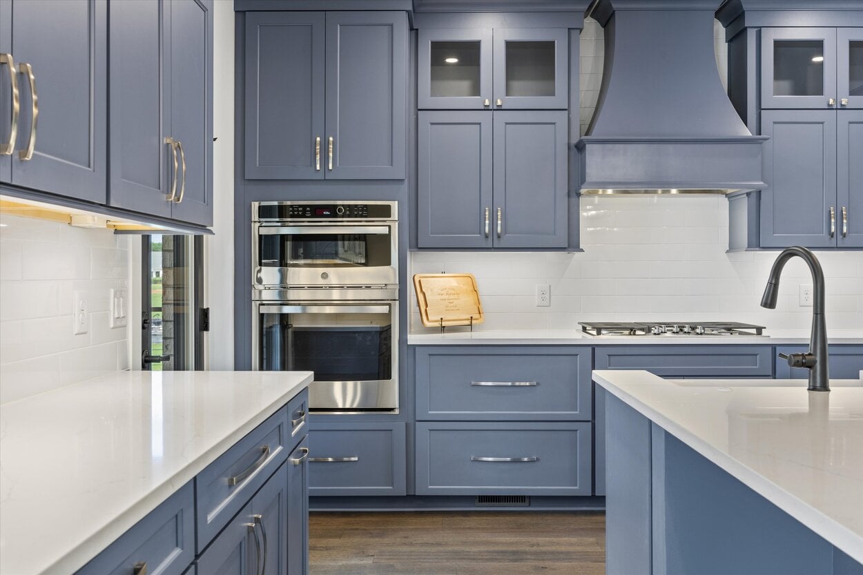 Close-up of stainless double oven and navy cabinetry in a Louisville, TN custom home kitchen